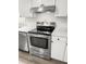 Stainless steel range and hood installed in a kitchen with white shaker cabinets at 7640 Hillview Ln, North Charleston, SC 29420