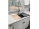 Modern kitchen sink with marble countertop, stainless steel fixtures, and wood cutting board at 7640 Hillview Ln, North Charleston, SC 29420