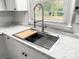 Modern farmhouse kitchen sink with marble countertop and stainless steel fixtures at 7640 Hillview Ln, North Charleston, SC 29420