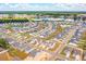 Aerial view of houses, streets, and a lake in a community at 780 Opal Wing St, Moncks Corner, SC 29461