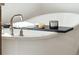 Freestanding bathtub with a wooden bath caddy at 780 Opal Wing St, Moncks Corner, SC 29461