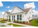 Side view of a white farmhouse with landscaping and walkway at 780 Opal Wing St, Moncks Corner, SC 29461