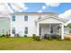 White two-story home with screened porch and landscaped yard at 780 Opal Wing St, Moncks Corner, SC 29461