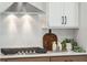 Kitchen with modern stove, white cabinets, and wood countertops at 780 Opal Wing St, Moncks Corner, SC 29461