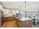 Spacious kitchen with island, stainless steel appliances, and hardwood floors at 780 Opal Wing St, Moncks Corner, SC 29461
