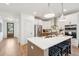 Open concept kitchen with island, stainless steel appliances, and hardwood floors at 780 Opal Wing St, Moncks Corner, SC 29461