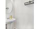 Modern bathroom with pedestal sink, floating shelves, and a large mirror at 8202 S Antler Dr, North Charleston, SC 29406