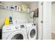 Convenient laundry room with washer, dryer, and storage shelves at 8202 S Antler Dr, North Charleston, SC 29406