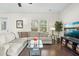Spacious living room with hardwood floors and large windows at 8202 S Antler Dr, North Charleston, SC 29406