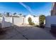Small backyard with concrete patio, white fence, and basketball hoop at 826 Rue Dr, Charleston, SC 29414