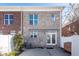 Brick home with patio, white fence, and AC unit at 826 Rue Dr, Charleston, SC 29414