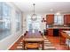 Bright dining area features wood table and chairs, kitchen access at 826 Rue Dr, Charleston, SC 29414