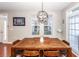Charming dining room with wood table, chandelier, and access to patio at 826 Rue Dr, Charleston, SC 29414