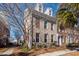 Brick townhouse with American flags, landscaping, and walkway at 826 Rue Dr, Charleston, SC 29414