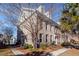 Brick townhouse with American flag, manicured landscaping, and sidewalk at 826 Rue Dr, Charleston, SC 29414