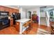 Open kitchen boasts wood cabinets, granite countertops & breakfast bar at 826 Rue Dr, Charleston, SC 29414