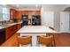 Modern kitchen with wood cabinets, granite countertops, and island at 826 Rue Dr, Charleston, SC 29414