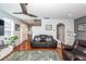 Living room with hardwood floors, leather furniture, and view of kitchen at 826 Rue Dr, Charleston, SC 29414
