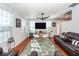 Living room with hardwood floors, large TV, and comfortable seating at 826 Rue Dr, Charleston, SC 29414