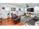 Bright living room with hardwood floors, comfy seating, and large TV at 826 Rue Dr, Charleston, SC 29414