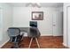 Home office with L-shaped desk and chair, near another room at 826 Rue Dr, Charleston, SC 29414