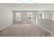 Spacious bonus room with carpeted floor and two windows at 9761 Transplanter Cir, Ladson, SC 29456
