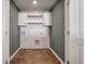 Laundry room with white cabinets, wood shelves and vinyl flooring at 9761 Transplanter Cir, Ladson, SC 29456