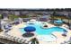 Expansive community pool area with lounge chairs, umbrellas, and well-maintained landscaping at 9761 Transplanter Cir, Ladson, SC 29456