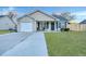Tan house with a white garage door and black shutters at 124 Pointer Dr, Goose Creek, SC 29445
