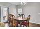 Dining room with hardwood floors, a wooden table, and red chairs at 128 Buchanan Cir, Goose Creek, SC 29445