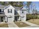 Two-story townhome with gray siding, attached garage, and landscaping at 128 Buchanan Cir, Goose Creek, SC 29445