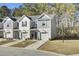 Three-story townhomes with gray siding, attached garages, and landscaping at 128 Buchanan Cir, Goose Creek, SC 29445