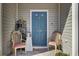 Quaint front porch with blue door, chairs, and potted plants at 128 Buchanan Cir, Goose Creek, SC 29445