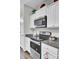 Modern kitchen with white cabinets, granite countertops, and stainless steel appliances at 128 Buchanan Cir, Goose Creek, SC 29445