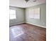 Empty bedroom with light sage walls and wood-look flooring at 1401 Rivers St, Walterboro, SC 29488