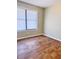 Bright bedroom with wood-look floors and window with blinds at 1401 Rivers St, Walterboro, SC 29488