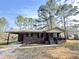 Brick ranch house with a covered porch, dark shutters, and a landscaped yard at 1401 Rivers St, Walterboro, SC 29488