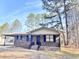 Brick ranch house with a covered porch, dark shutters, and a landscaped yard at 1401 Rivers St, Walterboro, SC 29488