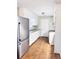 White kitchen with stainless steel appliances and wood-look floors at 1401 Rivers St, Walterboro, SC 29488
