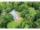 An aerial view showcasing the home's private setting amidst trees at 1433 Martins Point Rd, Wadmalaw Island, SC 29487