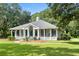 Charming one-story home with a large front porch and rocking chairs at 1433 Martins Point Rd, Wadmalaw Island, SC 29487