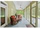 Relaxing screened porch with wicker furniture and ceiling fan at 1433 Martins Point Rd, Wadmalaw Island, SC 29487