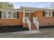 Renovated front entry with brick steps, white railings, and a green door at 1439 River Front Dr, Charleston, SC 29407