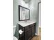 Dark brown vanity with a white countertop and rectangular mirror at 145 Clydesdale Cir, Summerville, SC 29486