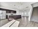 Open concept kitchen and living area with dark cabinetry and hardwood floors at 145 Clydesdale Cir, Summerville, SC 29486