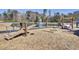 Community playground with seesaw and swings near pond at 145 Clydesdale Cir, Summerville, SC 29486