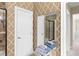 Bathroom with patterned wallpaper, a large mirror, and a shower at 1493 Nautical Chart Dr, Charleston, SC 29414