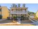 Two-story home with front porch, dormer windows, and landscaping at 1493 Nautical Chart Dr, Charleston, SC 29414