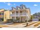 Charming two-story home boasts a spacious porch and landscaped front yard with a private driveway and detached garage at 1493 Nautical Chart Dr, Charleston, SC 29414