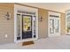 Inviting front entrance with glass-paneled black door with sidelight and elegant lantern-style sconces and 'beware of dog' doormat at 1493 Nautical Chart Dr, Charleston, SC 29414